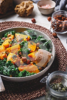 Season salad with grilled pumpkin, kale, chickpea, pepitas and nuts.