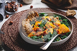 Season salad with grilled pumpkin, kale, chickpea, pepitas and nuts photo
