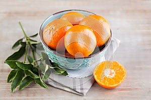 Season tangerine fruit on light brown wooden board background