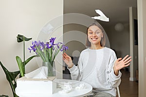 Seasonal allergy free. Happy young woman throws tissues up at home. Healthy life without of runny nose, itching or cough