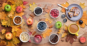 Seasonal autumn background. Frame of maple leaves and a cake, berries, raisins, apples, fruits, coffee and nuts over