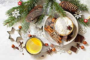 Seasonal baking winter background. Ingredients for Christmas baking - chocolate, spices, nuts, flour and eggs.