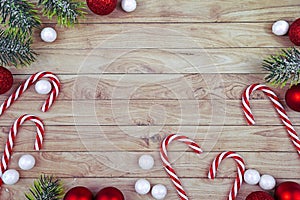 Seasonal Christmas flat lay with traditional red tree ornament baubles, white lace doily, candy canes and fir branches