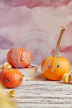 Seasonal cute Halloween pumpkins family with eyes. Funny seasonal vegetables. Copy space