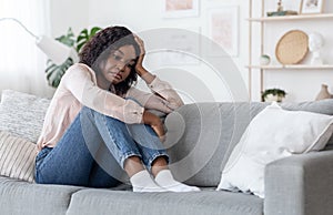 Seasonal Depression. Lonely Black Woman Sitting On Couch With Sad Face Expression