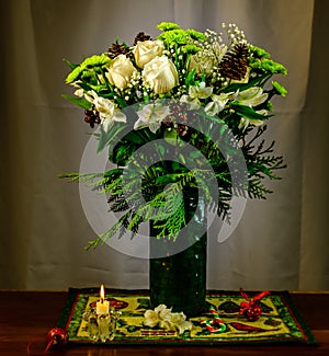 Seasonal flower arrangement with winter accessories.