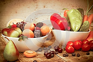 Seasonal fruit and vegetable in bowl on rustic table, healthy fresh organic vegetarian food photo