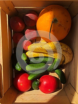 Seasonal fruits and vegetables in a wooden box