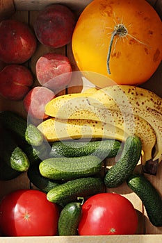 Seasonal fruits and vegetables in a wooden box