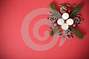 Seasonal greeting card concept with candles, pinecones and evergreen branches