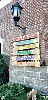 Seasonal holiday decoration pallet sign on a brick wall