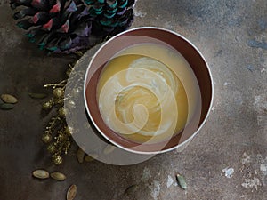 Seasonal homemade pumpkin soup on a wooden background