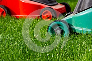 Seasonal maintenance works in garden, lawn movers in action, green grass cutting, lawn care, English lawn