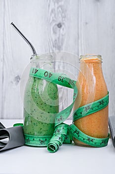 Seasonal Matcha green vegan smoothie and pumpkin carrot smoothie drink detox Breakfast with measuring tape and rubber