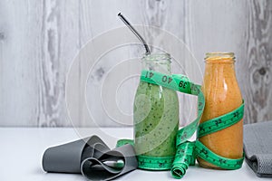 Seasonal Matcha green vegan smoothie and pumpkin carrot smoothie drink detox Breakfast with measuring tape and rubber