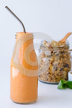 Seasonal pumpkin carrot smoothie drink detox with eco metal drinking straw Glass jar granola muesli oatmeal breakfast