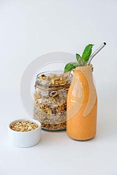 Seasonal pumpkin carrot smoothie drink detox with eco metal drinking straw Glass jar granola muesli oatmeal breakfast