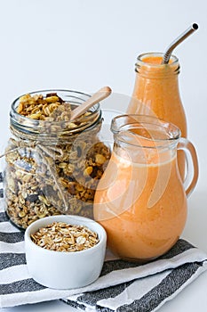 Seasonal pumpkin carrot smoothie drink detox with eco metal drinking straw Glass jar granola muesli oatmeal breakfast