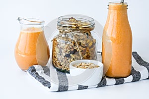 Seasonal pumpkin carrot smoothie drink detox with eco metal drinking straw Glass jar granola muesli oatmeal breakfast