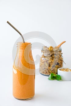 Seasonal pumpkin carrot smoothie drink detox with eco metal drinking straw Glass jar granola muesli oatmeal breakfast