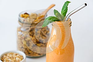 Seasonal pumpkin carrot smoothie drink detox with eco metal drinking straw Glass jar granola muesli oatmeal breakfast