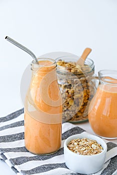 Seasonal pumpkin carrot smoothie drink detox with eco metal drinking straw Glass jar granola muesli oatmeal breakfast