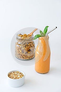 Seasonal pumpkin carrot smoothie drink detox with eco metal drinking straw Glass jar granola muesli oatmeal breakfast