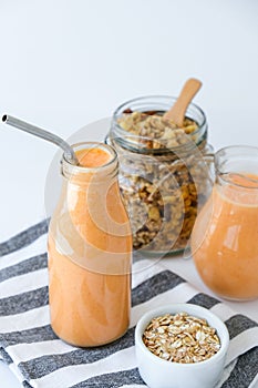 Seasonal pumpkin carrot smoothie drink detox with eco metal drinking straw Glass jar granola muesli oatmeal breakfast