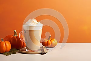 Seasonal pumpkin spice latte on orange background