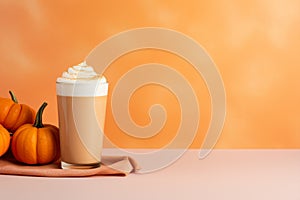 Seasonal pumpkin spice latte on orange background