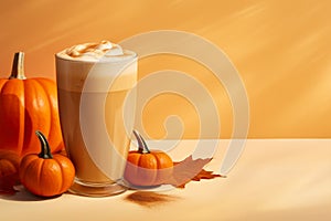 Seasonal pumpkin spice latte on orange background