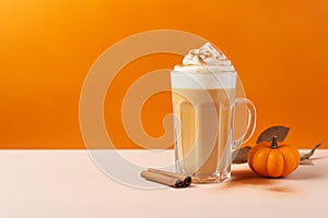 Seasonal pumpkin spice latte on orange background