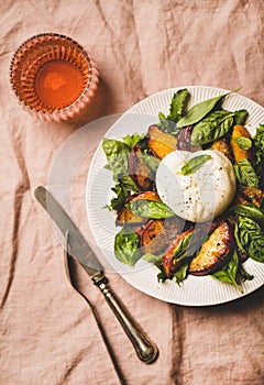 Seasonal salad with burrata soft cheese and rose wine