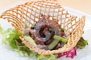 Seasonal squid of spring with lettuce salad and asparagus on white plate background