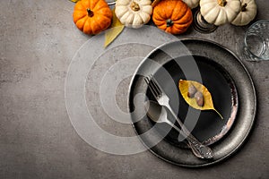 Seasonal table setting with pumpkins and other  autumn decor on grey background, flat lay.