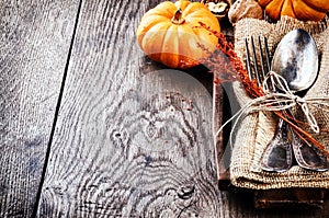 Seasonal table setting with small pumpkins