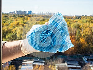 seasonal washing home window glass by blue rag