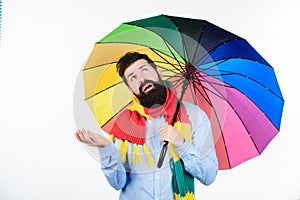 Seasonal weather forecast. Man bearded hipster hold colorful umbrella. It seems to be raining. Rainy days can be tough