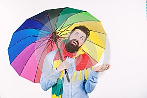 Seasonal weather forecast. Man bearded hipster hold colorful umbrella. It seems to be raining. Rainy days can be tough