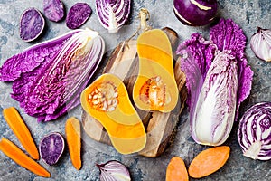 Seasonal winter autumn fall vegetables over gray stone table. Plant based vegan or vegetarian cooking concept. Clean eating food