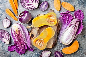 Seasonal winter autumn fall vegetables over gray stone table. Plant based vegan or vegetarian cooking concept. Clean eating food