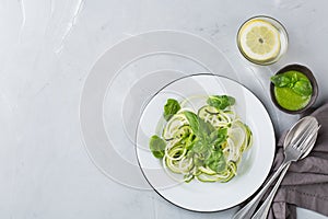 Seasonal zucchini spaghetti pasta noodles with spinach pesto sauce