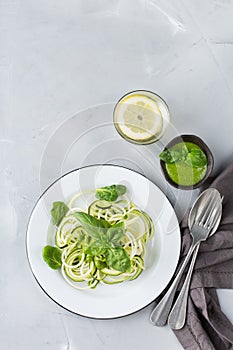 Seasonal zucchini spaghetti pasta noodles with spinach pesto sauce