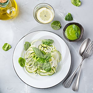 Seasonal zucchini spaghetti pasta noodles with spinach pesto sauce