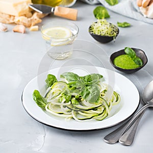 Seasonal zucchini spaghetti pasta noodles with spinach pesto sauce