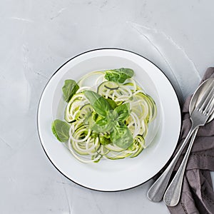 Seasonal zucchini spaghetti pasta noodles with spinach pesto sauce