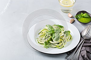 Seasonal zucchini spaghetti pasta noodles with spinach pesto sauce