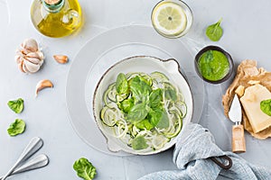 Seasonal zucchini spaghetti pasta noodles with spinach pesto sauce