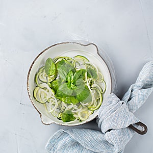 Seasonal zucchini spaghetti pasta noodles with spinach pesto sauce