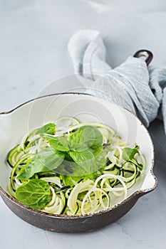 Seasonal zucchini spaghetti pasta noodles with spinach pesto sauce